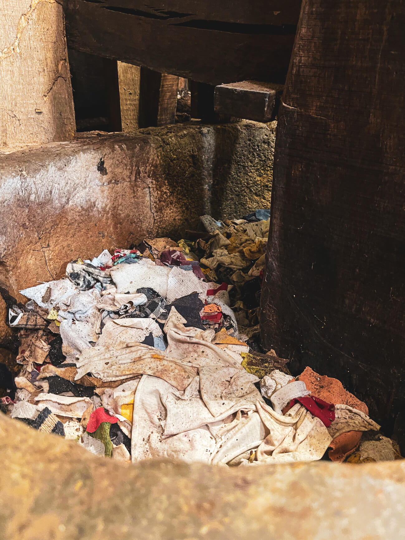 Scraps of fabric in an old stone trough